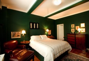 Bold-design-bedroom-with-dark-green-wall-and-dark-brown-wood-furniture